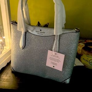 Kate spade silver glitter purse. Brand new never used. Packaging still on purse.